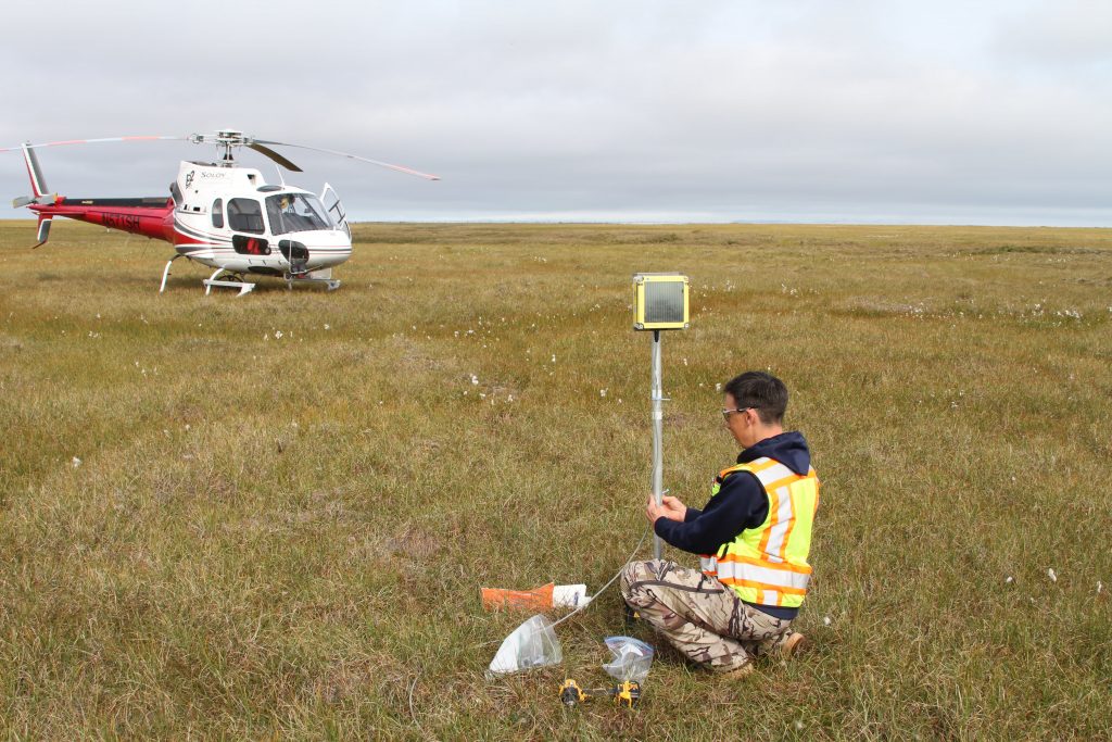 Brian fixing the data logger of one of the ice road monitoring stations on the North Slope